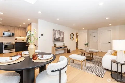 a kitchen with stainless steel appliances granite countertop a stove top oven a sink and a refrigerator