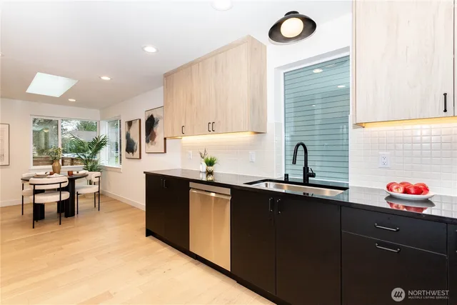 a kitchen with granite countertop sink and cabinets