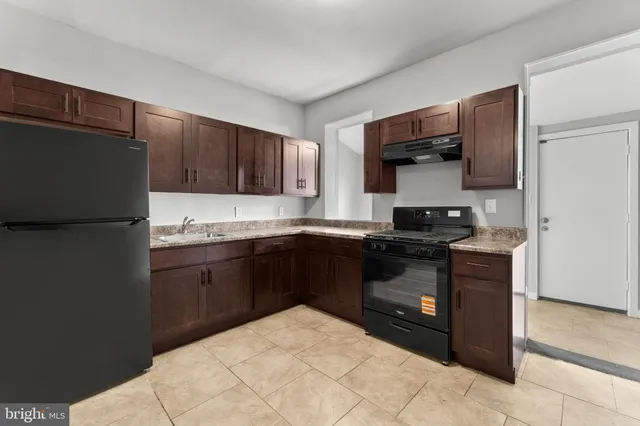 a kitchen with stainless steel appliances granite countertop a refrigerator and a stove