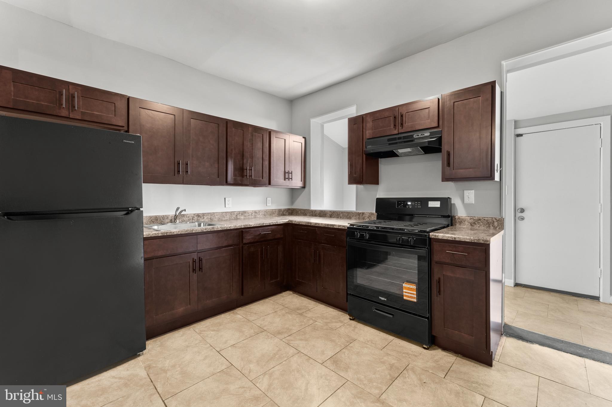 1249 Carroll Street Baltimore, MD 21230 - Photo 12 of 29 a kitchen with stainless steel appliances granite countertop a refrigerator and a stove