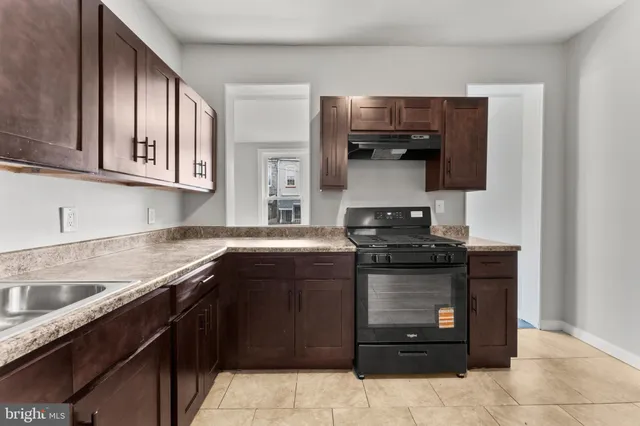 a kitchen with stainless steel appliances granite countertop a stove and a sink