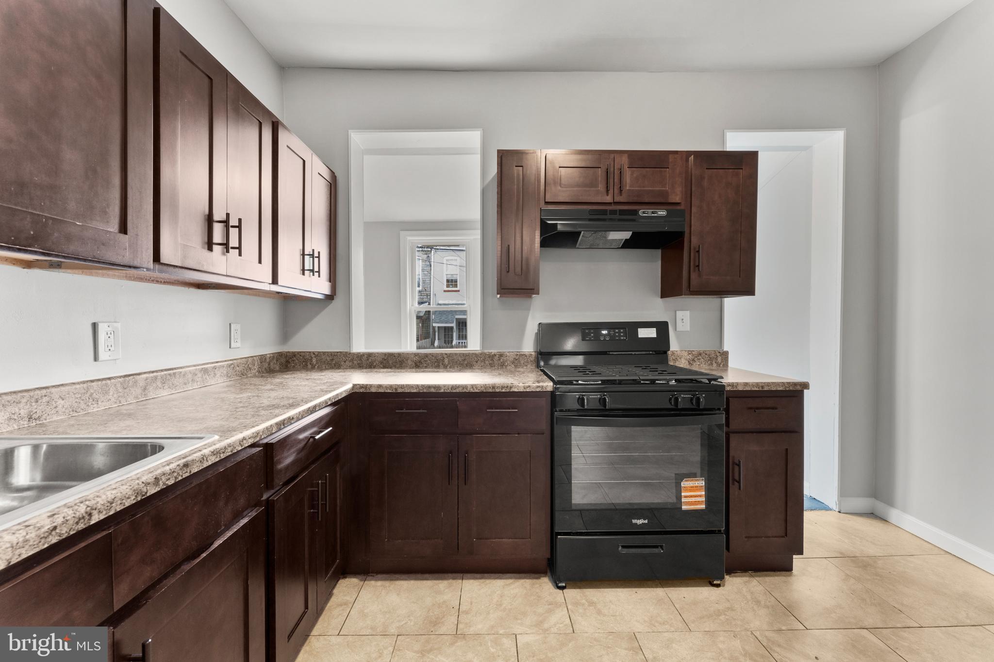 1249 Carroll Street Baltimore, MD 21230 - Photo 14 of 29 a kitchen with stainless steel appliances granite countertop a stove and a sink