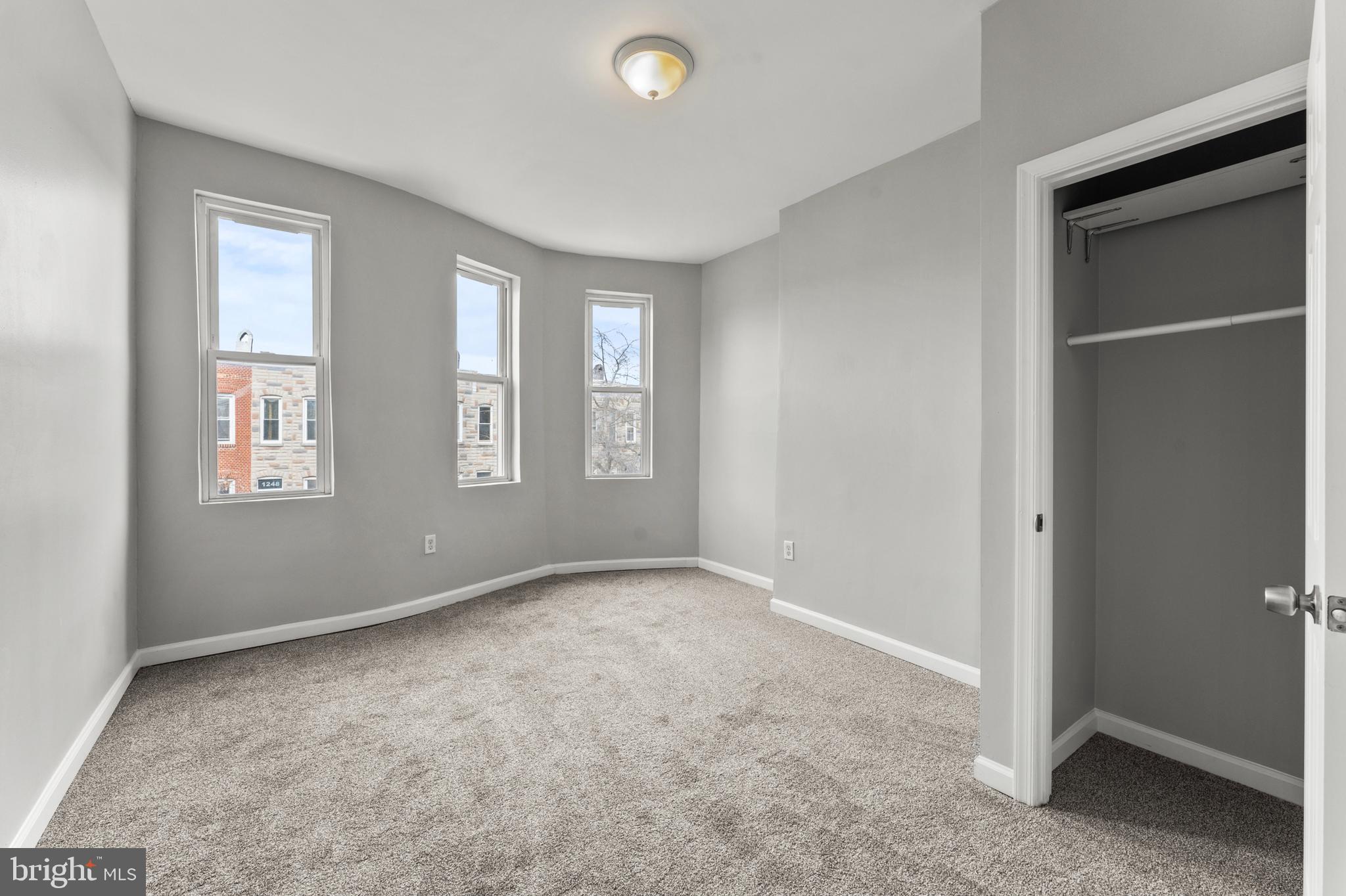 1249 Carroll Street Baltimore, MD 21230 - Photo 17 of 29 a view of an empty room with windows