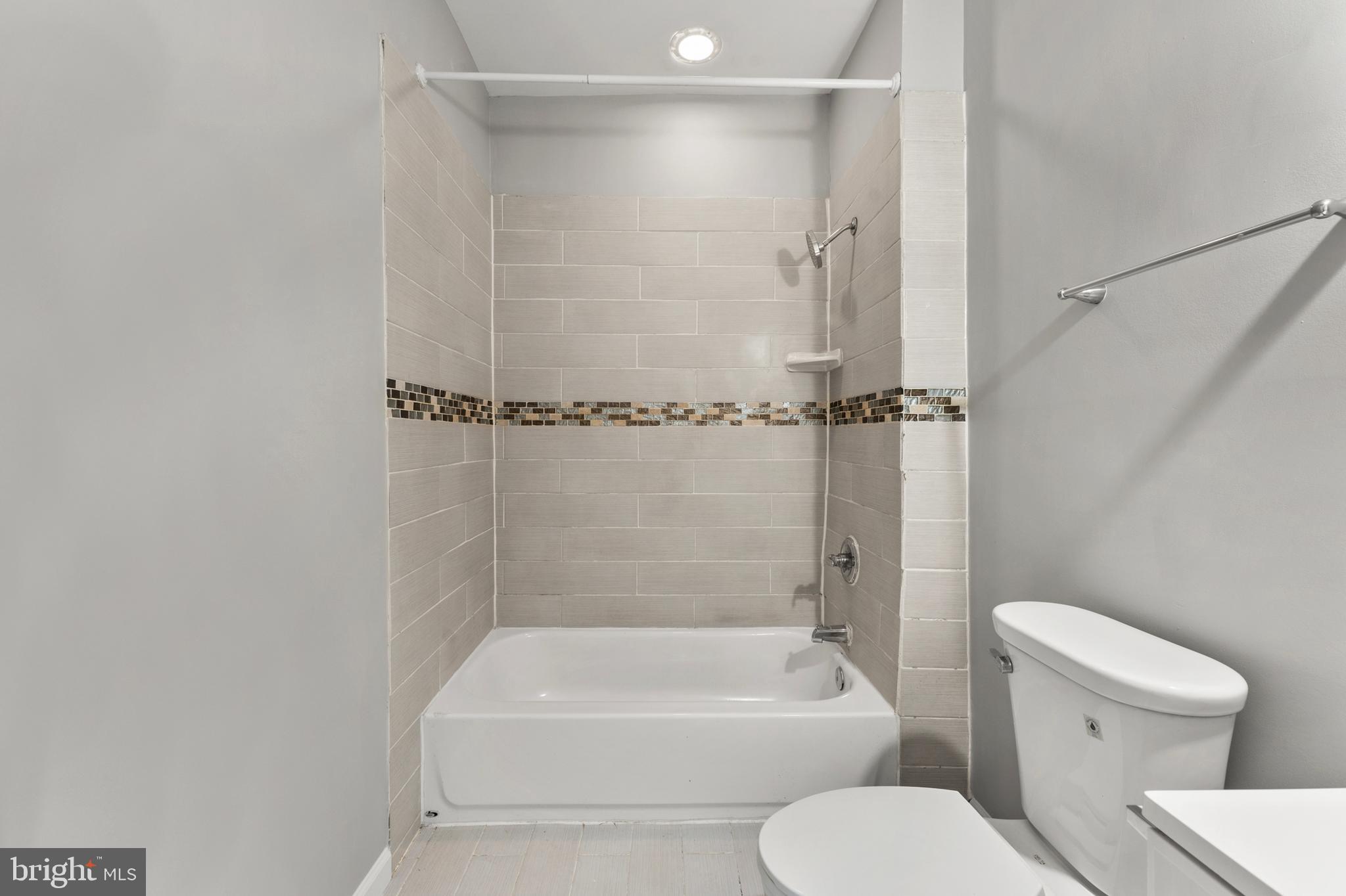 1249 Carroll Street Baltimore, MD 21230 - Photo 23 of 29 a bathroom with a toilet and a shower