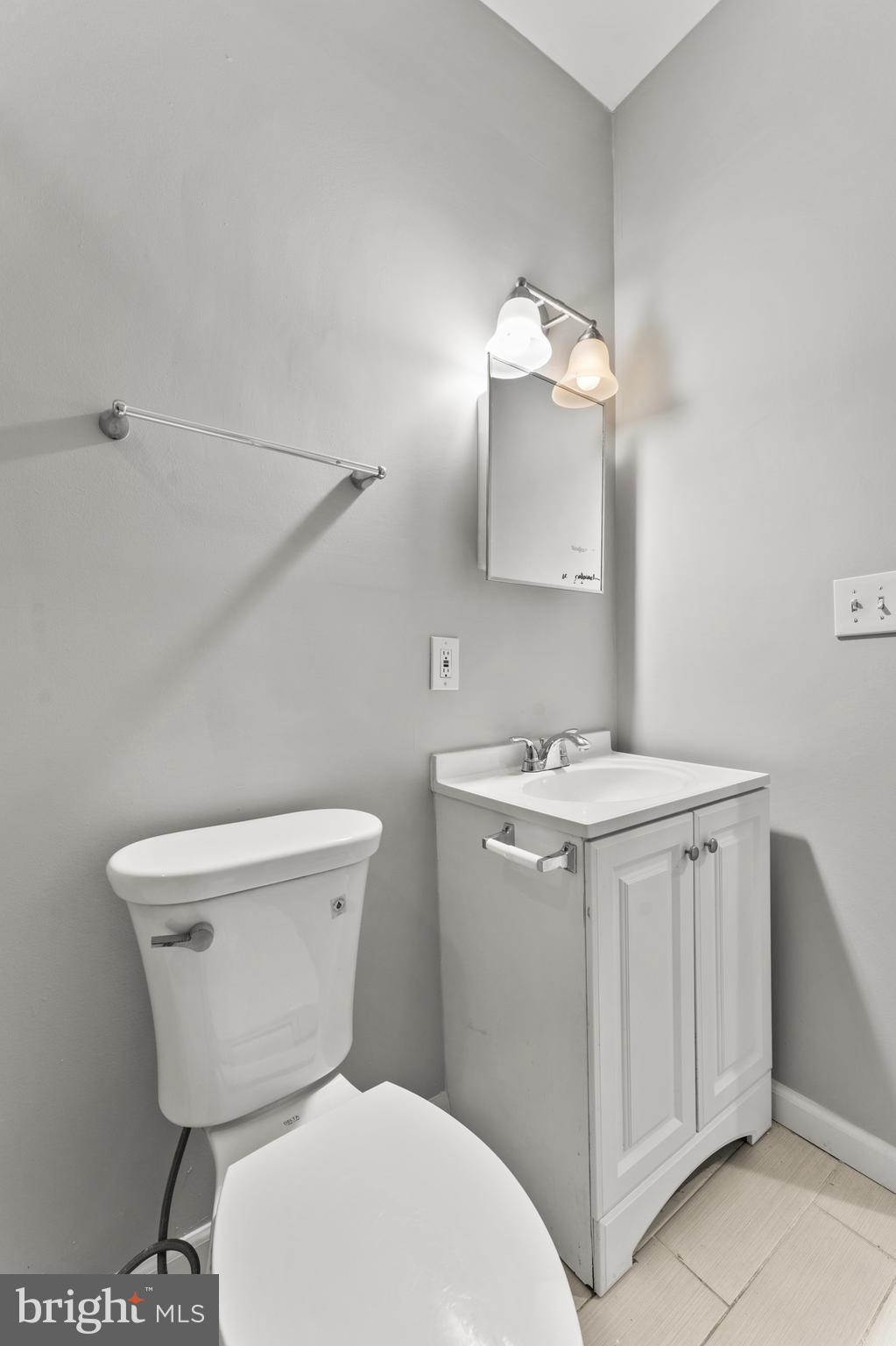 1249 Carroll Street Baltimore, MD 21230 - Photo 24 of 29 a bathroom with a toilet sink and mirror