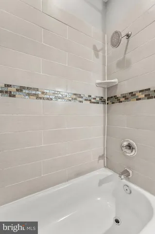 a bathroom with a tub and a shower