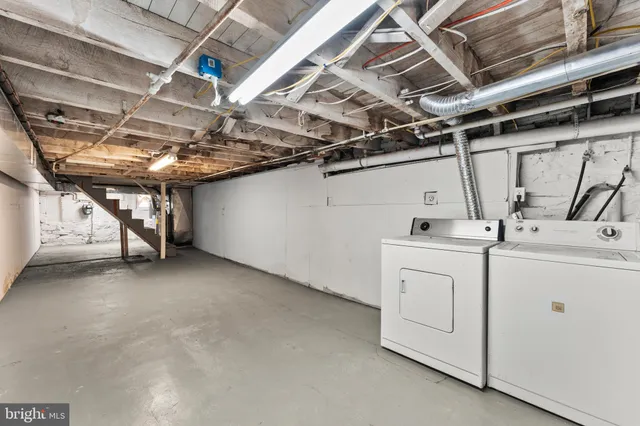 a view of storage and utility room with washer and dryer