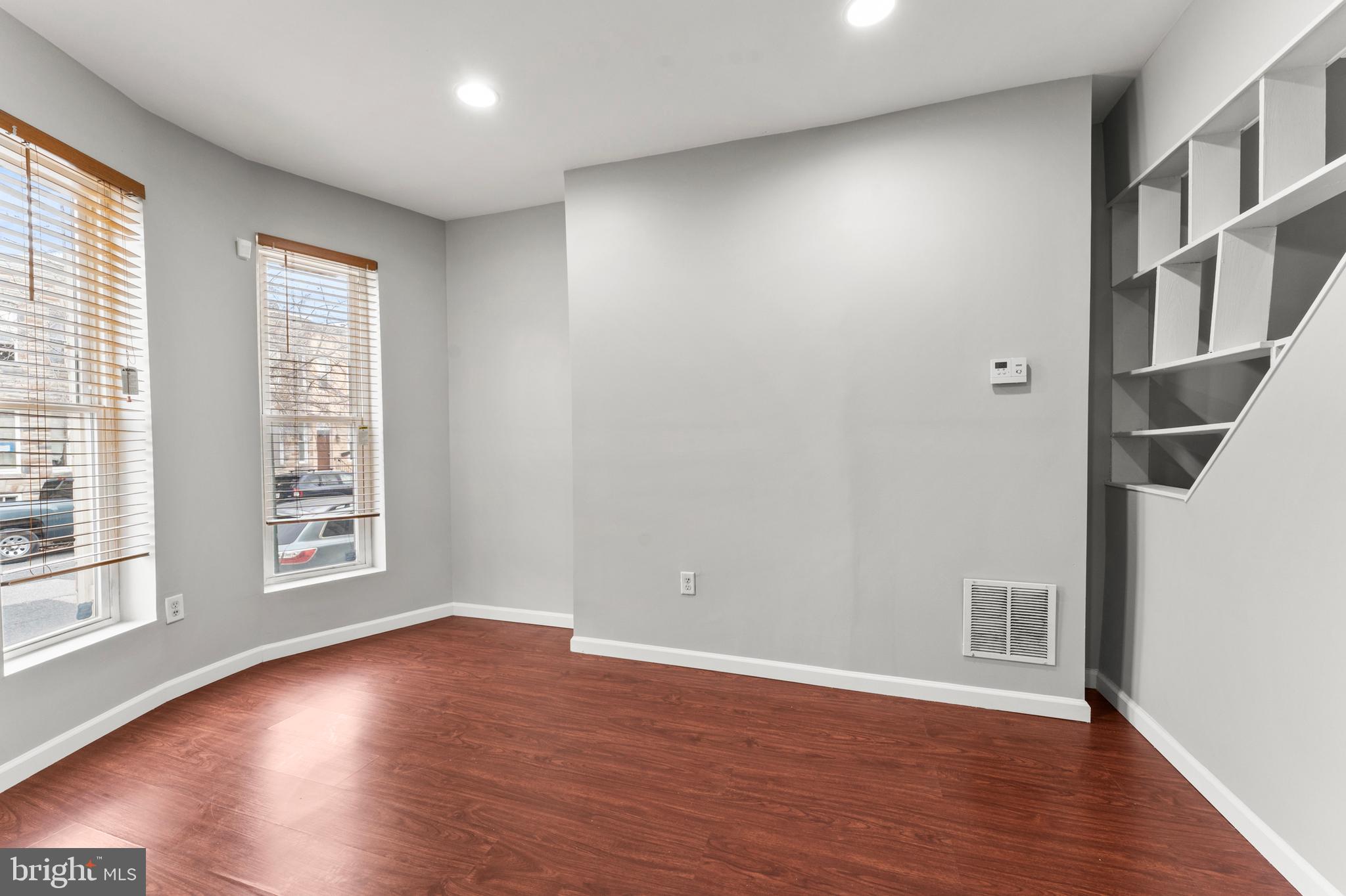 1249 Carroll Street Baltimore, MD 21230 - Photo 5 of 29 a view of an empty room with wooden floor and a window