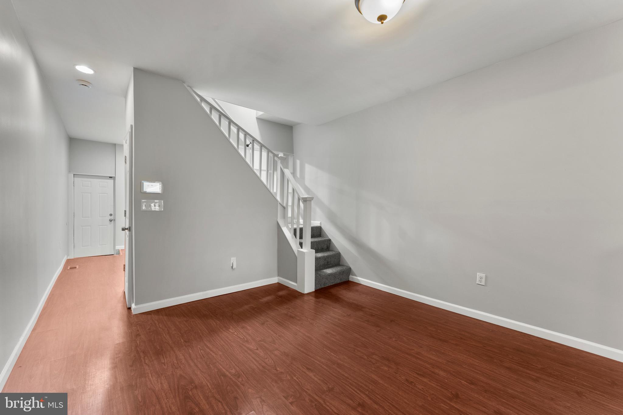 1249 Carroll Street Baltimore, MD 21230 - Photo 7 of 29 a view of an empty room with wooden floor
