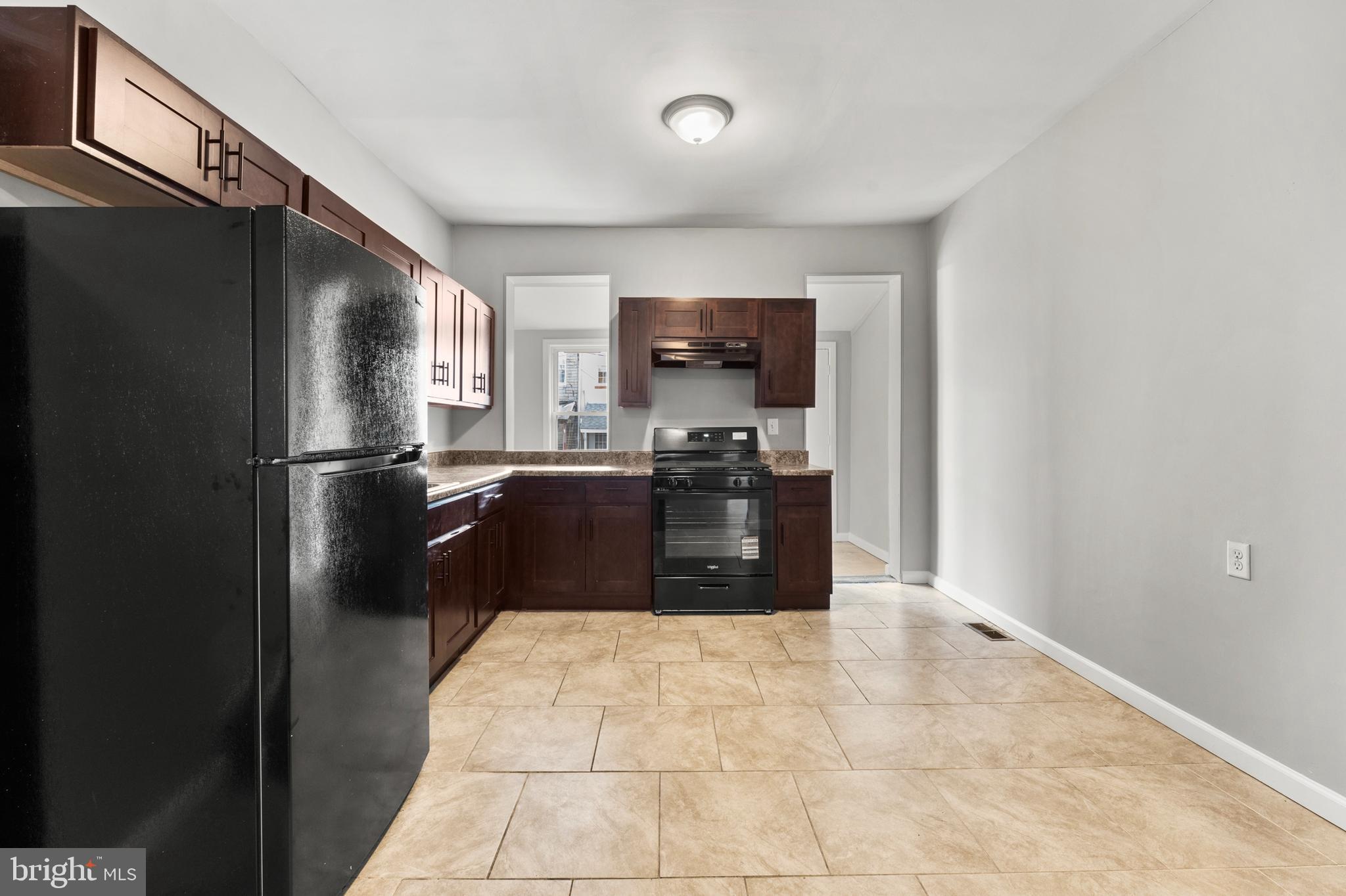 1249 Carroll Street Baltimore, MD 21230 - Photo 10 of 29 a kitchen with granite countertop a refrigerator and a sink