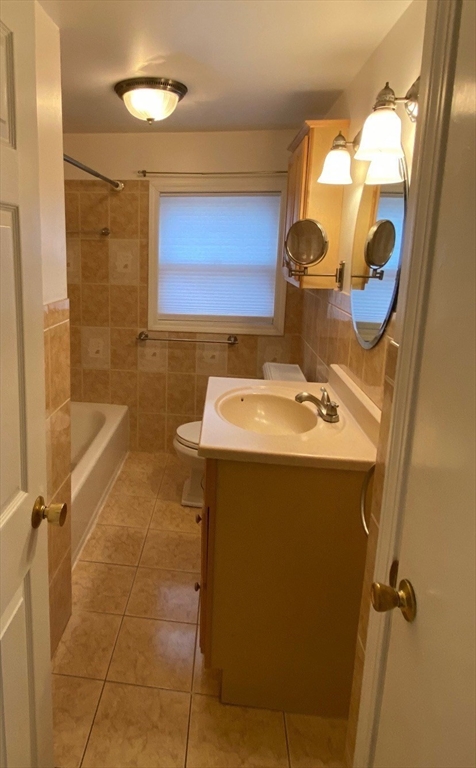 118 Spruce Road Norwood, MA 02062 - Photo 4 of 39 a bathroom with a sink and mirror with bathtub