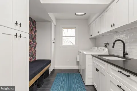 a large kitchen with a large window and stainless steel appliances