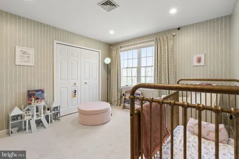 a spacious bedroom with a bed and a couch