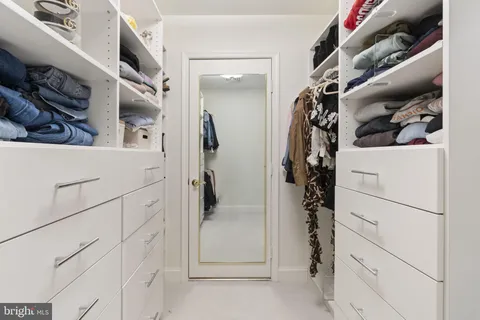 a bathroom with a toilet sink double vanity and mirror