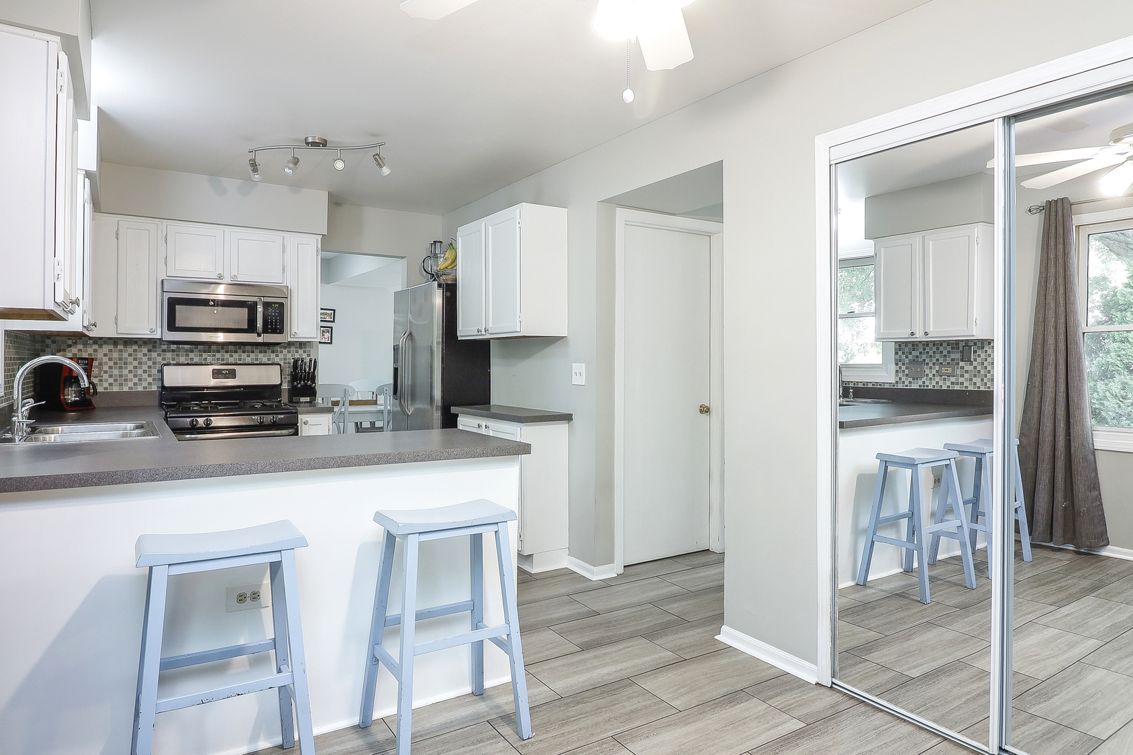 3 Hickory Oaks Court Bolingbrook, IL 60490 - Photo 5 of 21 a kitchen with kitchen island granite countertop a sink counter top space appliances and cabinets