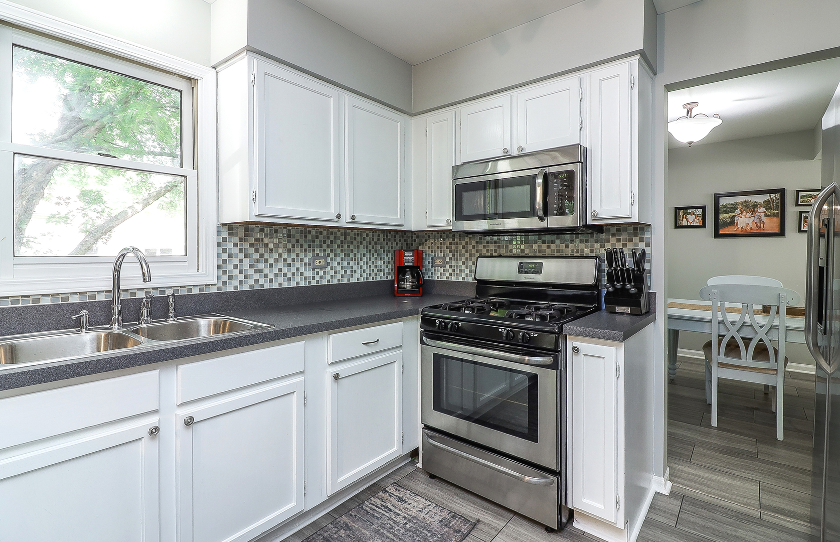 3 Hickory Oaks Court Bolingbrook, IL 60490 - Photo 7 of 21 a kitchen with cabinets stainless steel appliances a sink and a window