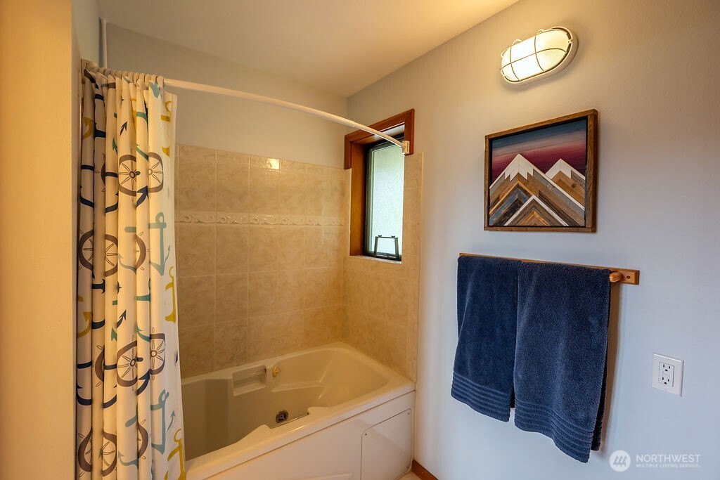 3757 Mud Bay Road Lopez Island, WA 98261 - Photo 23 of 40 a bathroom with a bathtub and a shower