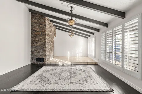 a view of empty room with wooden floor and fireplace