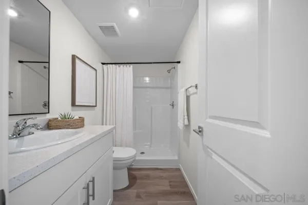 a bathroom with a glass shower door