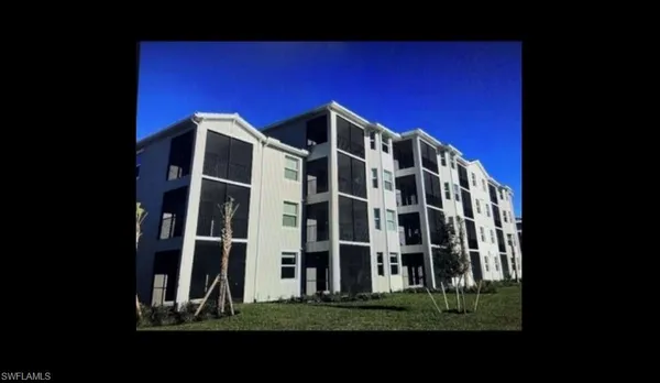 a view of a building with a yard