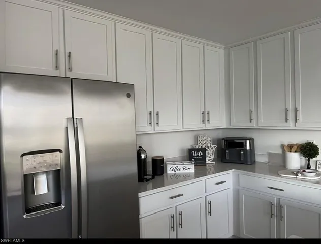 a kitchen with stainless steel appliances granite countertop a refrigerator a stove and cabinets