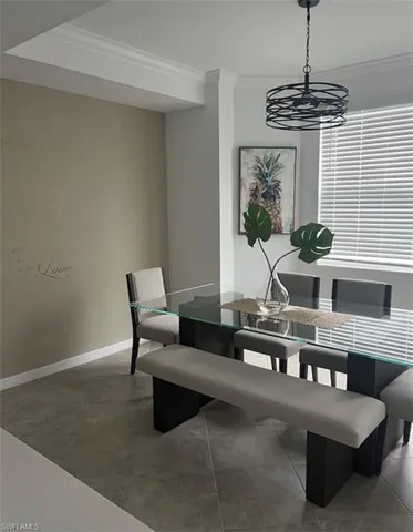 a living room with furniture a chandelier and a window
