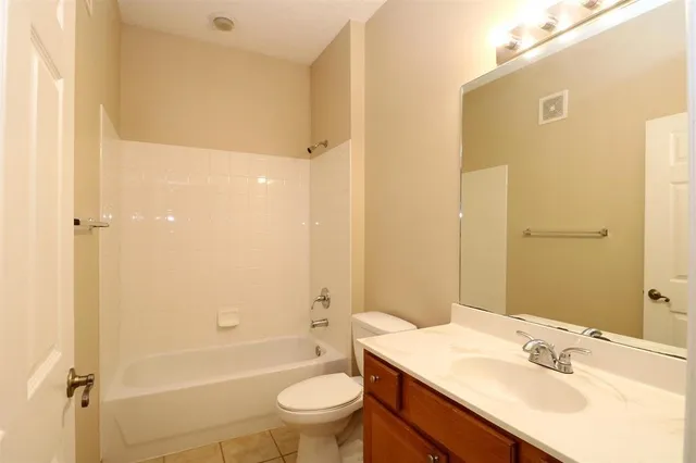 a bathroom with a sink toilet tub and shower