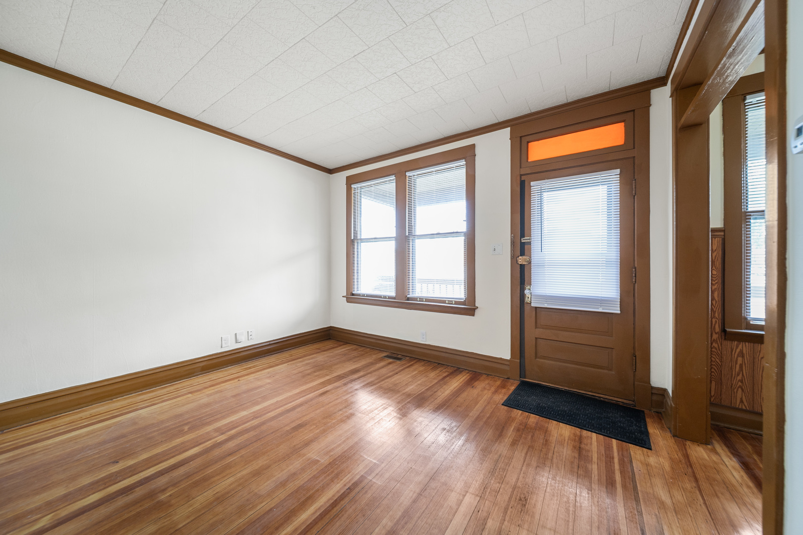 7120 41st Street Stickney, IL 60402 - Photo 3 of 13 a view of an empty room with glass door and wooden floor