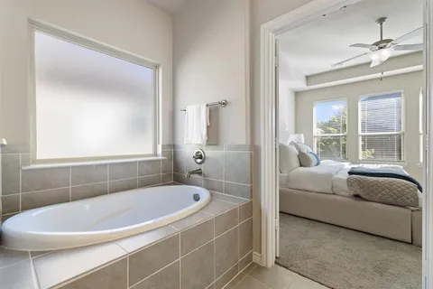 a bathroom with a bathtub and window