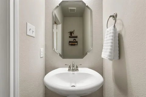 a bathroom with a sink a mirror and vanity