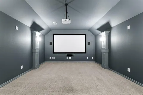 a view of an empty room with windows and chandelier