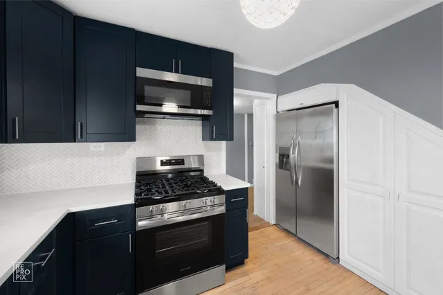 a kitchen with a refrigerator stove and microwave