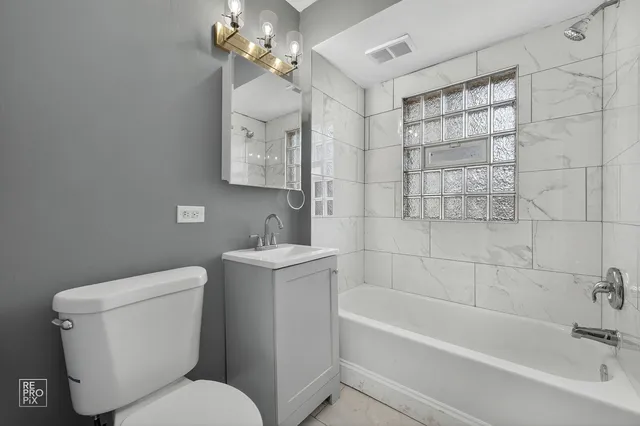 a bathroom with a toilet sink and bathtub