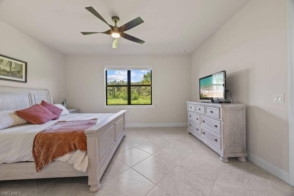 5931 Mayflower Way Ave Maria, FL 34142 - Photo 13 of 34 a bedroom with a bed and a dresser