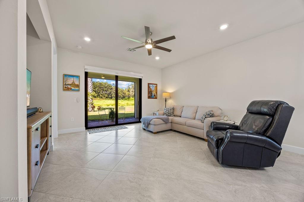 5931 Mayflower Way Ave Maria, FL 34142 - Photo 16 of 34 a living room with furniture and a large window