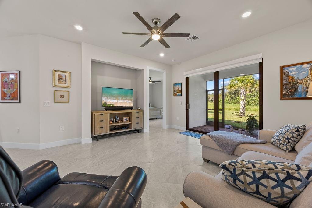 5931 Mayflower Way Ave Maria, FL 34142 - Photo 17 of 34 a living room with furniture and a large window
