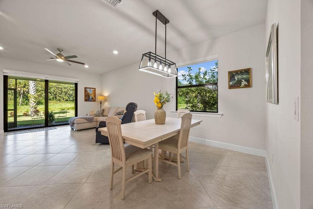 5931 Mayflower Way Ave Maria, FL 34142 - Photo 18 of 34 a view of a dining room with furniture window and outside view