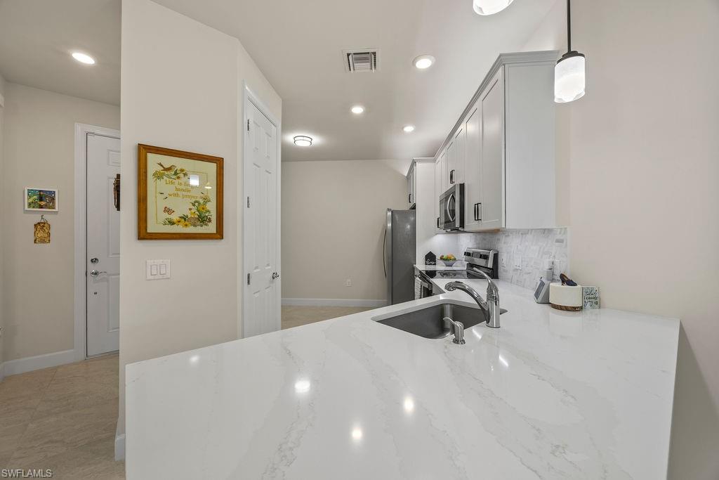 5931 Mayflower Way Ave Maria, FL 34142 - Photo 20 of 34 a kitchen with sink and window