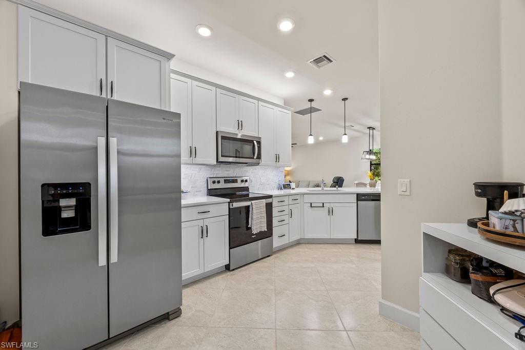 5931 Mayflower Way Ave Maria, FL 34142 - Photo 21 of 34 a kitchen with a refrigerator a sink and cabinets