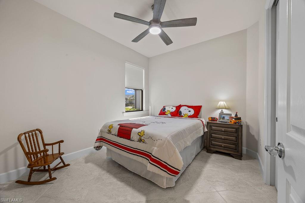 5931 Mayflower Way Ave Maria, FL 34142 - Photo 22 of 34 a bedroom with a bed and a chair