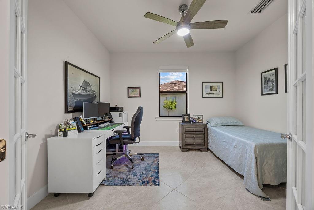 5931 Mayflower Way Ave Maria, FL 34142 - Photo 25 of 34 a bedroom with a workspace