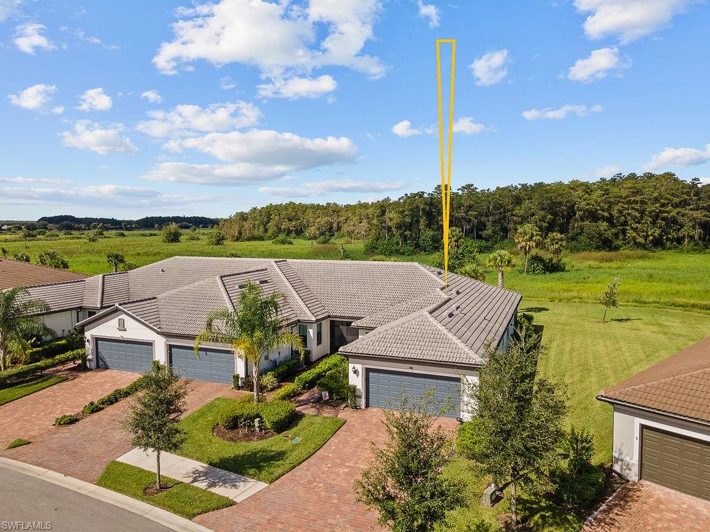 5931 Mayflower Way Ave Maria, FL 34142 - Photo 29 of 34 an aerial view of a house with a garden