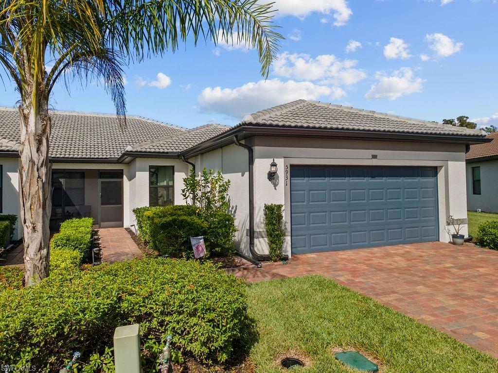 5931 Mayflower Way Ave Maria, FL 34142 - Photo 3 of 34 front view of a house with a yard