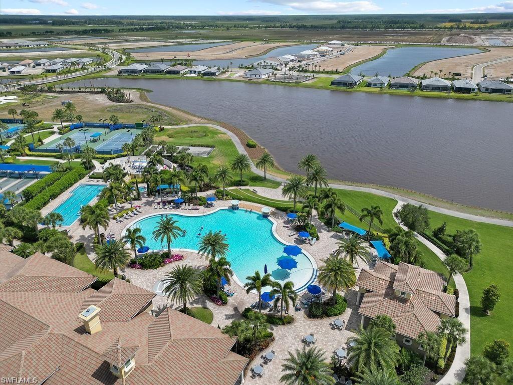 5931 Mayflower Way Ave Maria, FL 34142 - Photo 32 of 34 an aerial view of lake and residential houses with outdoor space