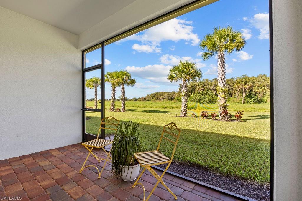5931 Mayflower Way Ave Maria, FL 34142 - Photo 8 of 34 a view of a porch with a table and chairs