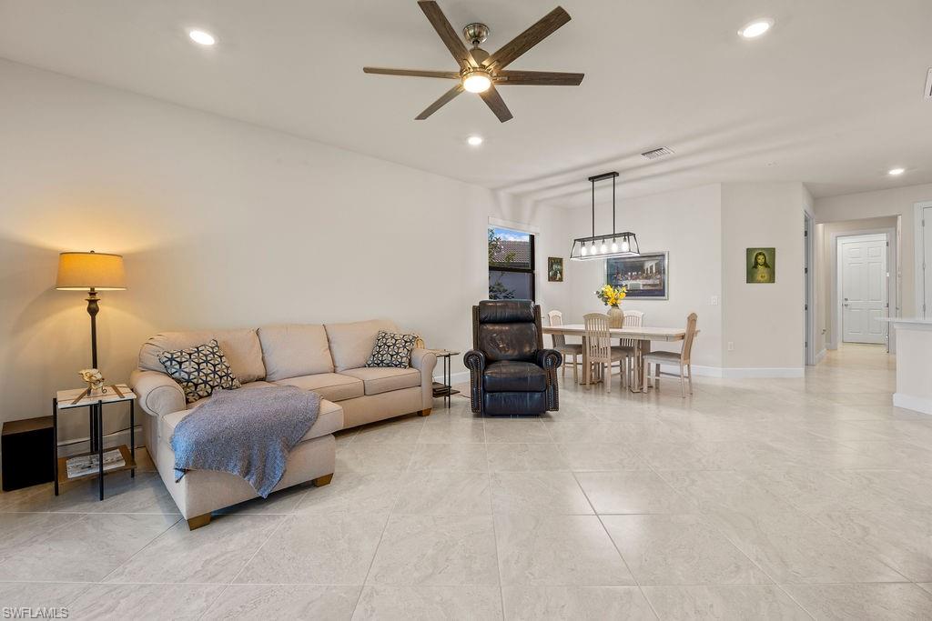 5931 Mayflower Way Ave Maria, FL 34142 - Photo 10 of 34 a living room with furniture and kitchen view