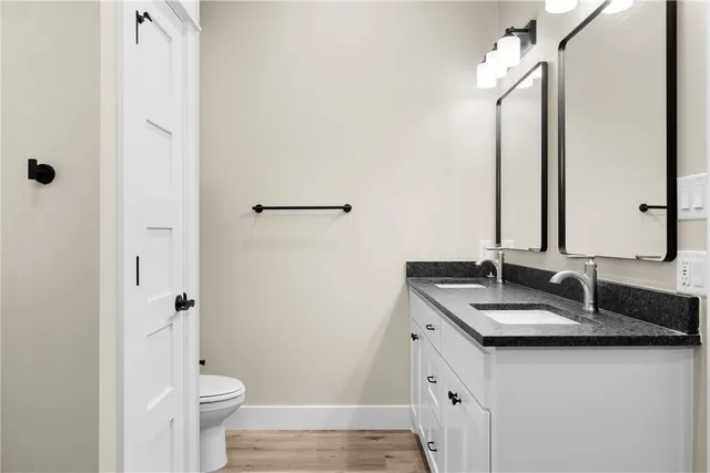 a bathroom with a double vanity sink toilet and shower