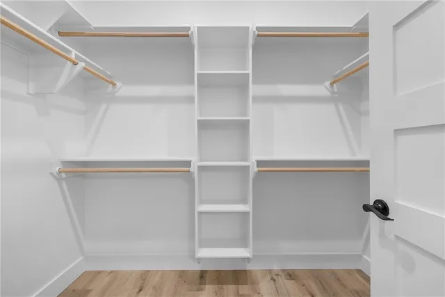 a bathroom with a granite countertop sink a mirror and shower