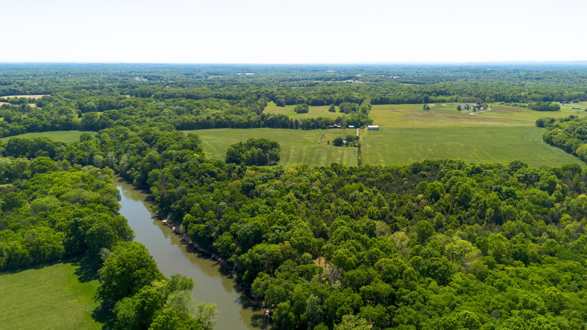 3680 Clark Road Lewisburg, TN 37091 - Photo 20 of 97 an aerial view of green landscape with trees houses and lake view