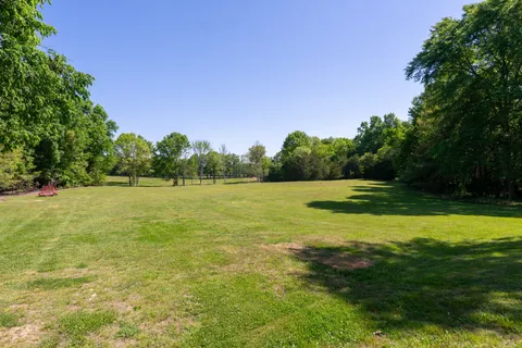 a view of a house with a yard and a garden
